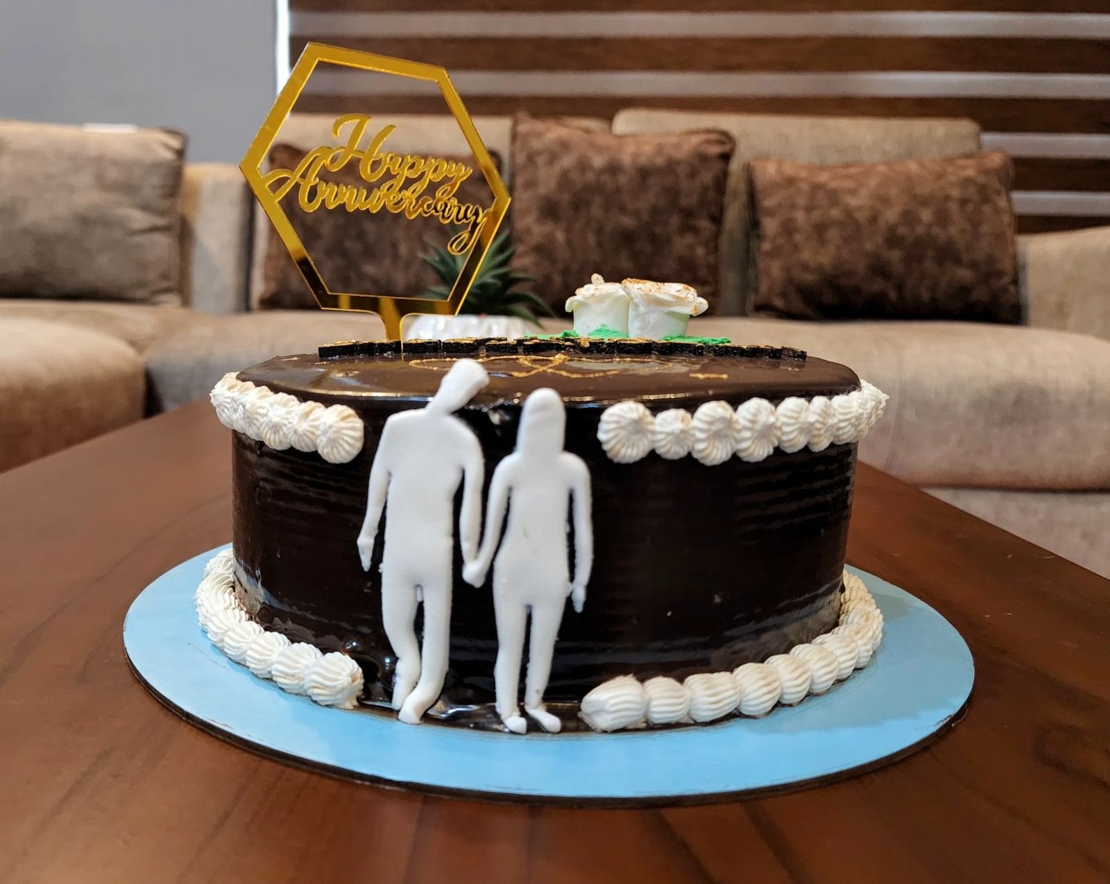 Anniversary celebration cake with couple topper