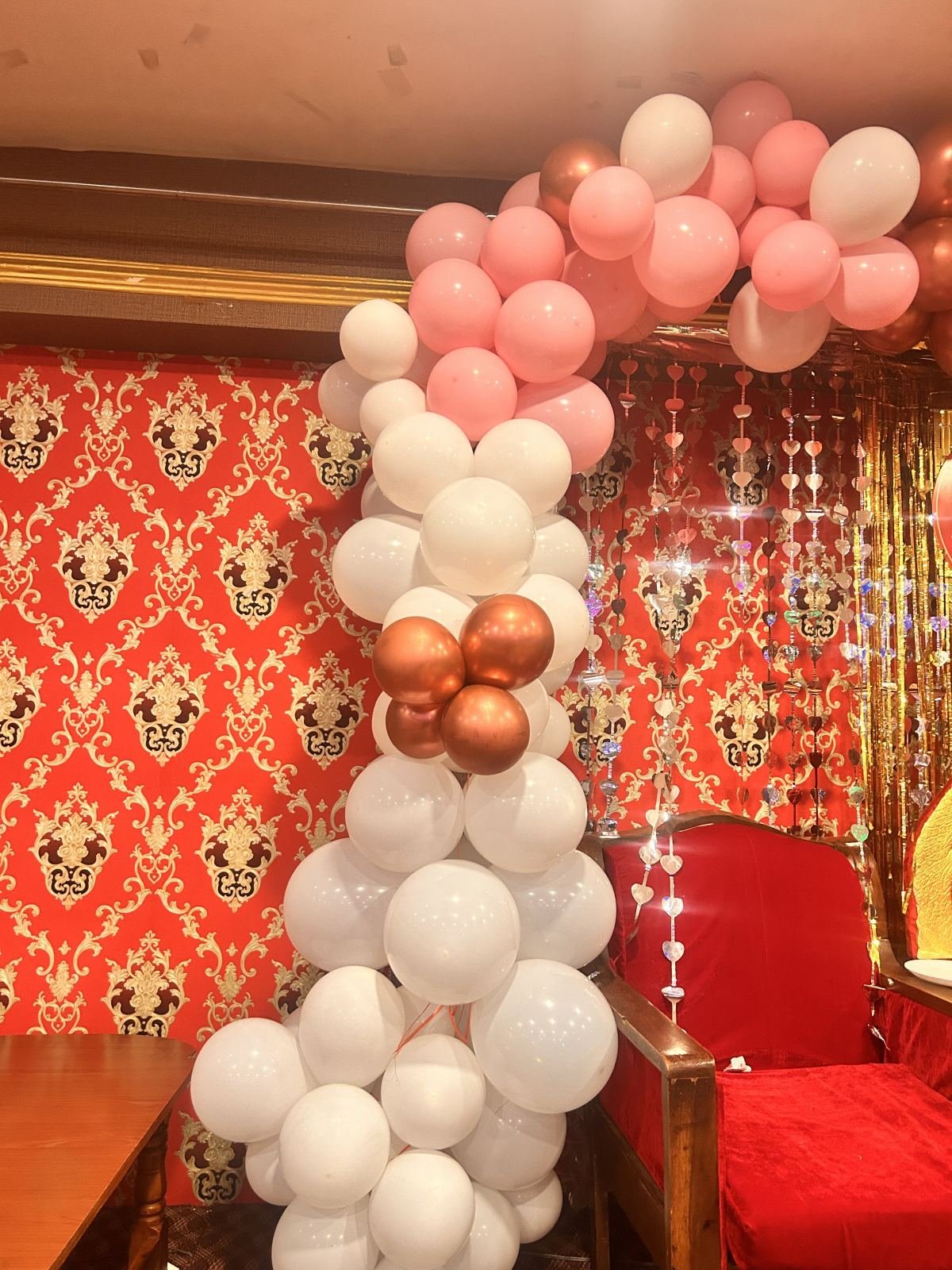 Pink, white and bronze balloon arch for a baby shower