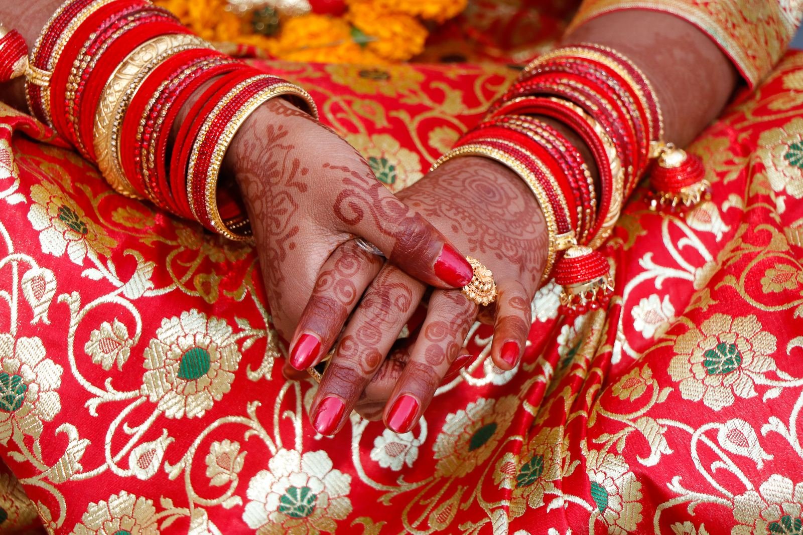 Bride with mehendi and red bangles