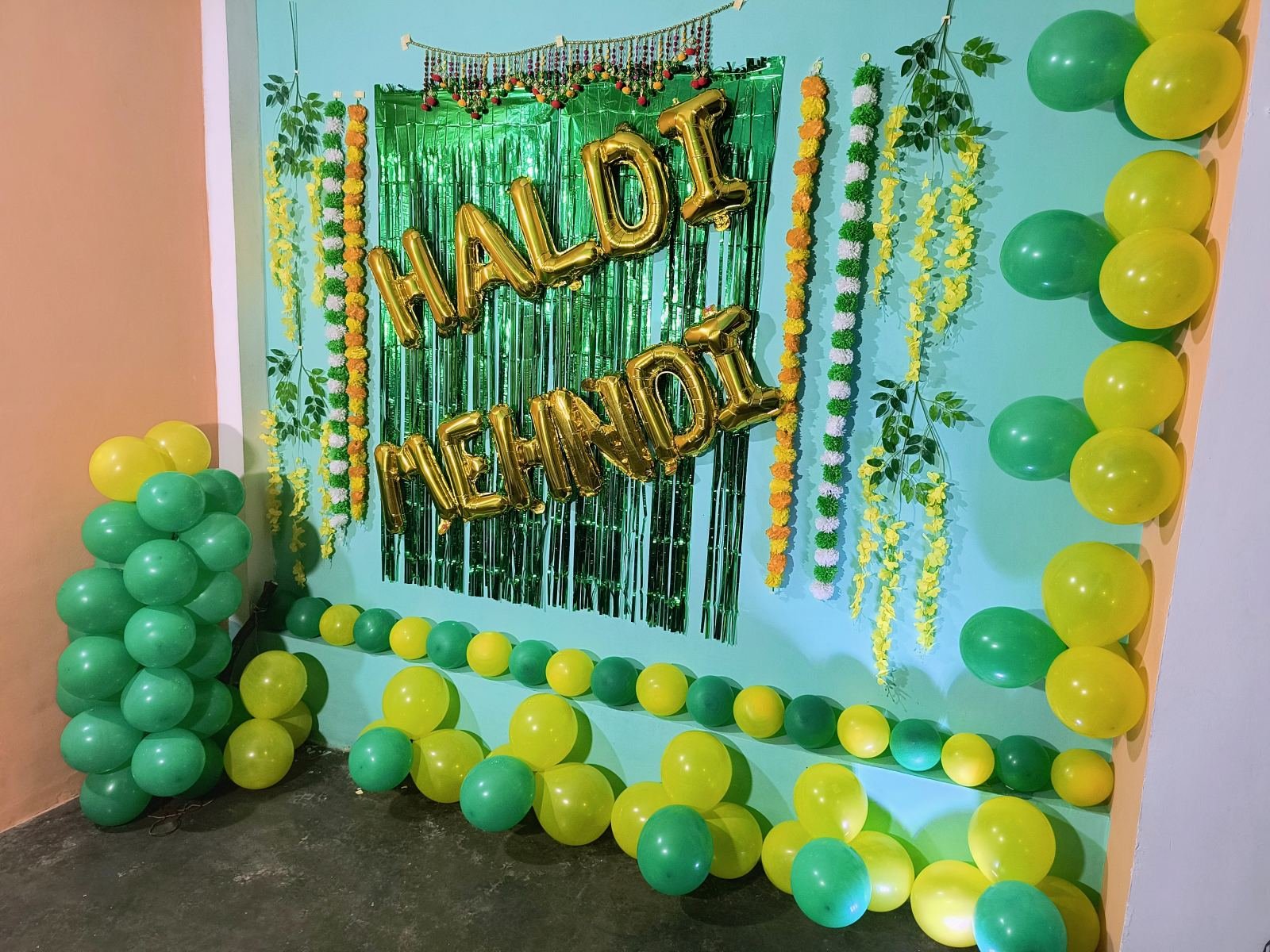 Haldi and mehendi backdrop with yellow and green balloons
